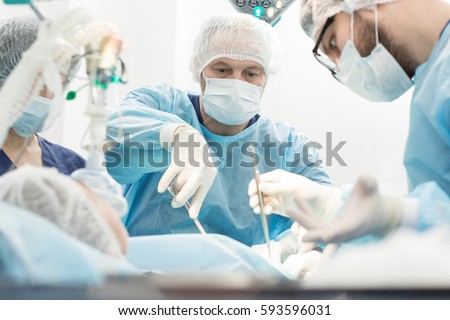 Another surgery. Surgery medical team operating in a surgery room of the hospital mature surgeon leading an operation profession professionalism occupation teamwork medical people doctors concept Royalty-Free Stock Photo #593596031