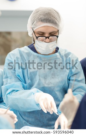Responsible work. Vertical shot of a male surgeon operating in surgery room professionalism occupation career incision scalpel working sterile trustworthy busy doctor clinical medicine health concept 