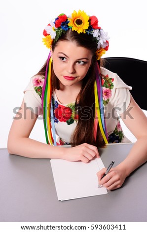 businesswoman with note and pen by a desk.