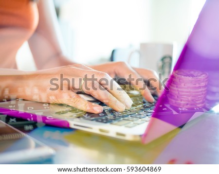 Double Exposure of Pretty Young woman using laptop computer. Female working on laptop in a cafe and money coins
