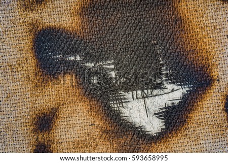 burned canvas- charred piece of cloth. Photo 7360x4912 pixels.