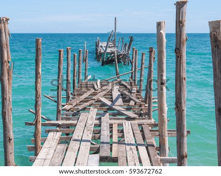 Wide shot of broken old wood pier lie into the nice blue sea refer to obstacle of business or life