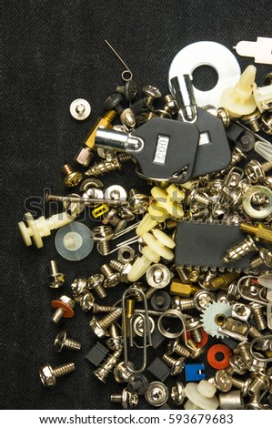 techno backgrounds - various bolts, screws, washers, nuts and other computer small fasteners on black fabric