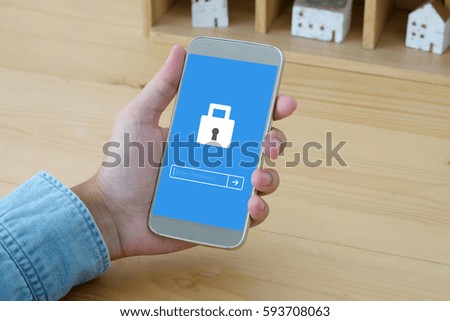 Hand holding smart phone with password login on screen background, cyber security concept