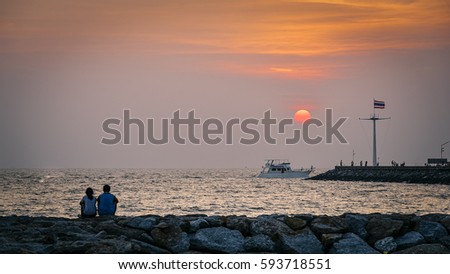 People watching the sunset at sea.