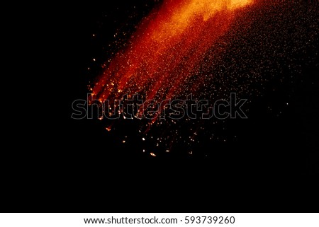 abstract powder splatted background,Freeze motion of orange powder exploding/throwing orange dust on black background