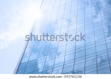 blue glass from skyscraper building against the sun