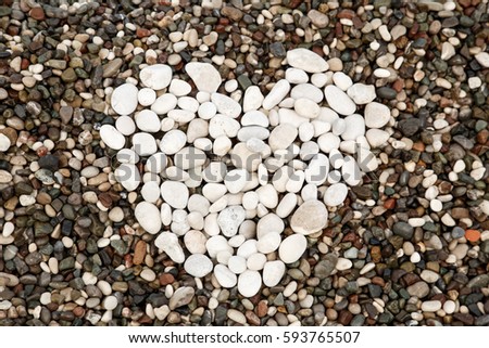 heart from white stones on a background sea pebbles