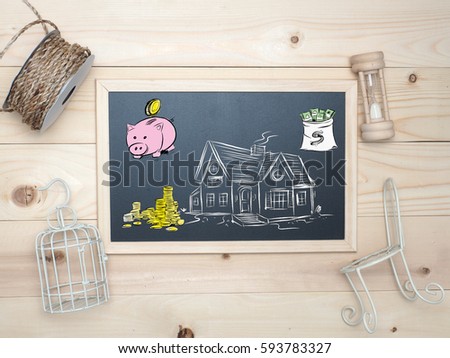 Top view blackboard .Draw prepare money for the house . Top board on wood background.