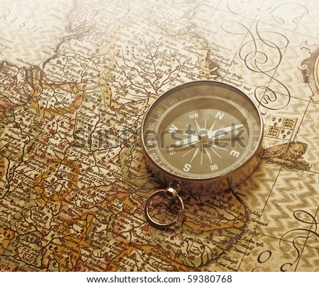A compass lies on an age-old map Royalty-Free Stock Photo #59380768