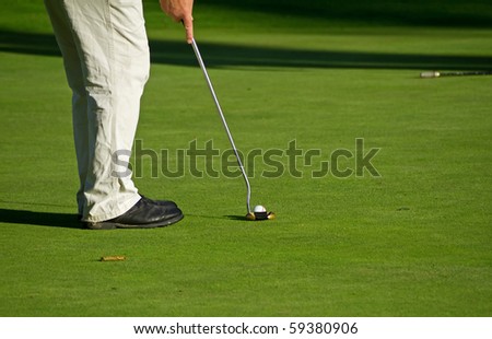 Man playing golf on sunny course