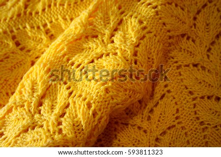 Drawing on a sweater (hand-knitted) in the form of braids from leaves of yellow color