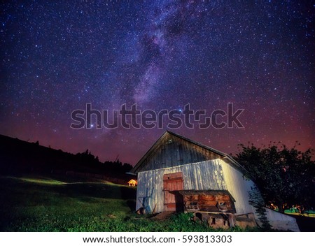 View at the starry sky and old house on mountain slope. Dramatic and picturesque scene. Location place Carpathian, Ukraine, Europe. Discover the world of beauty. Artistic picture. Astrophotography.