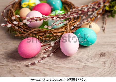 Easter composition of the branches,Easter bunny, cakes, tulips colored eggs cooked for the holiday on the wooden background