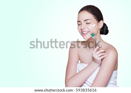 Derma Roller. Young Woman and her hands in mezoroller cream on face, cover skin defects, fight against signs of aging skin, natural stimulation of collagen and elastin   
    
