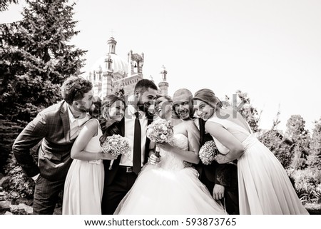 Black and white picture of happy wedding couple and newlyweds hugging on the backyard