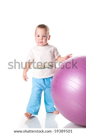 Little boy with the fitness ball on white background