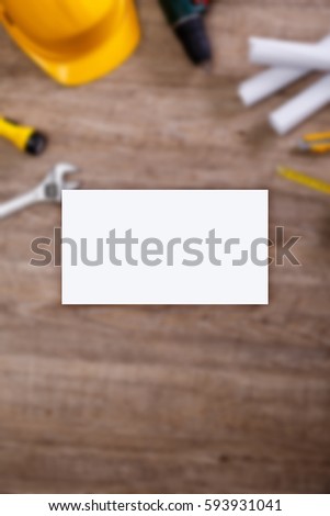 Business card mockup. Helmet, screwdriver and flashlight. Construction design. Tape measure. Adjustable wrench, paper plans and knife.
