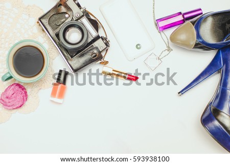 White office desk table with laptop, smartphone, camera and glass. Top view with copy space, flat lay.