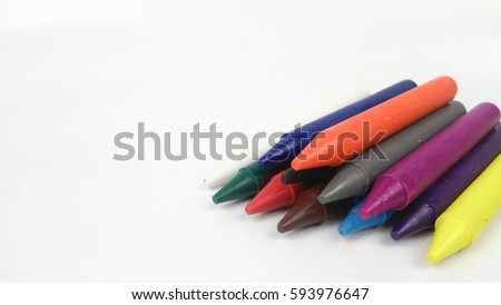 Colorful kids crayon in green pail isolated on white background. 