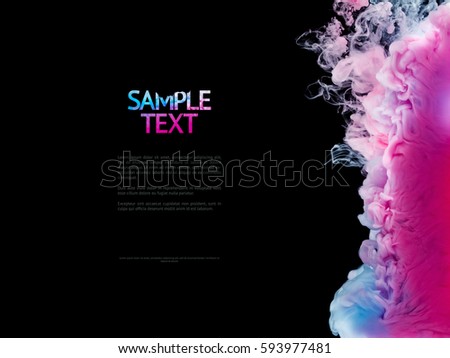 Color splashes of ink isolated on black background. Abstract paint in water, photographed in motion. Copy space with text.