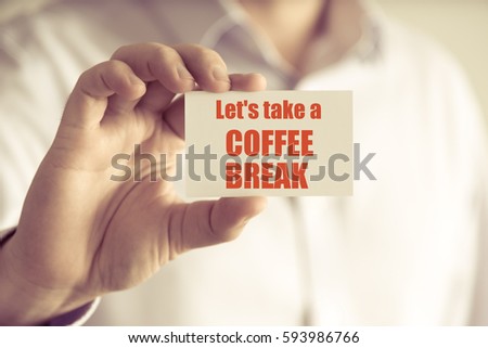 Closeup on businessman holding a card with text LETS TAKE A COFFEE BREAK, business concept image with soft focus background and vintage tone