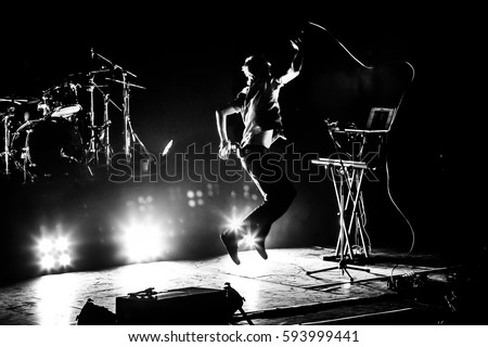Band on stage. Vocalist silhouette  Royalty-Free Stock Photo #593999441