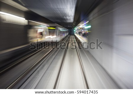 Blurred motion subway moving into tunnel, abstract background