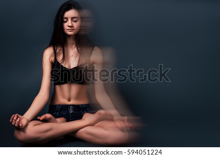 Girl in Lotus position, time fo yoga, woman practising yoga at blue background