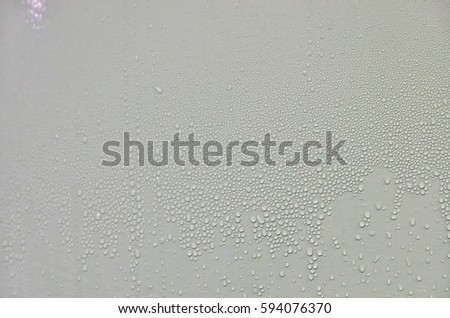 Water drops formed by condensation in a cold metal tank