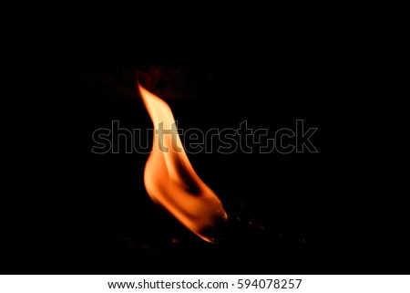  Tiny fire flame on dark background.Fire flame isolated on black isolated background - Beautiful yellow, orange and red and red blaze fire flame texture style.