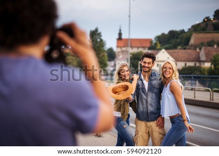Group of friends taking a picture in the city. They are all happy and full of joy.