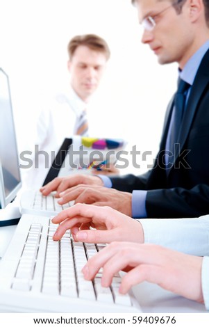 Image of secretary hands typing document on the background of working people