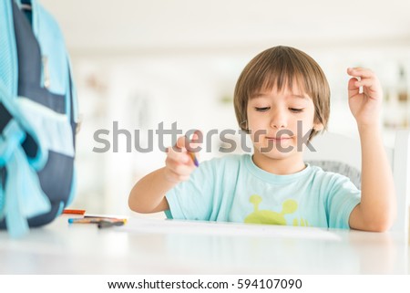 Little child drawing on the table