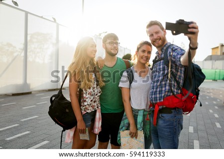 Young happy students taking selfie and laughing