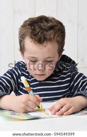 young boy with pen