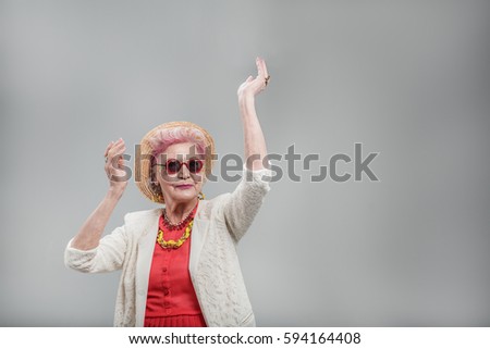 Emotional elderly woman wearing sunglasses