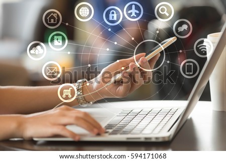 Woman use laptop and smartphone with IOT, internet of things conceptual sign, internet era, internet in every day lifes Royalty-Free Stock Photo #594171068