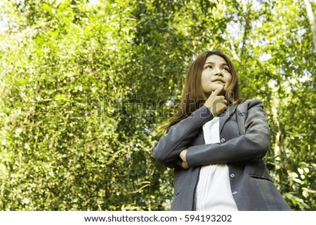 Young Beautiful Asian Businesswoman and Engineering guy in Grey suit in the forest, Success Business in his life and Achieve Target in working life. Working and Lifestyle Concept.
