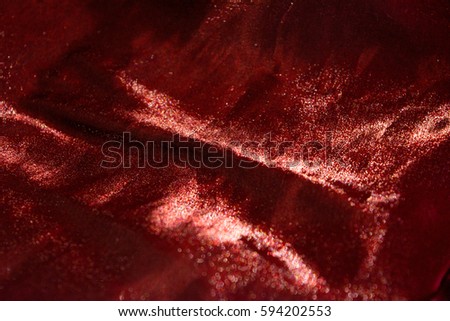 Photo of the texture of the horizontal fold on the red glitter fabric. Royalty-Free Stock Photo #594202553