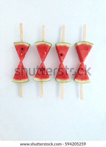 Watermelon slice popsicles on white background  
