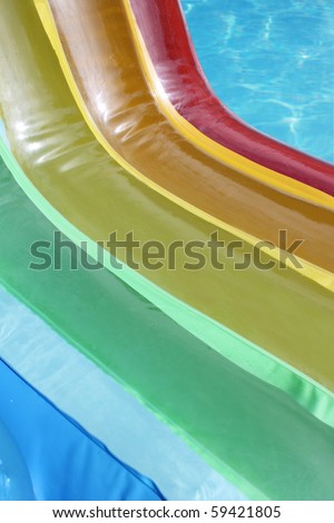 a close up of an inflatable rainbow colored chair in a swimming pool
