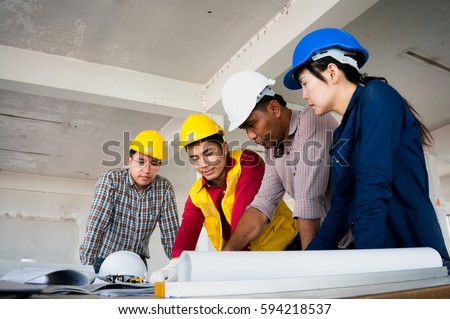 Engineers wearing safety helment meeting and discuss for work planning on site
