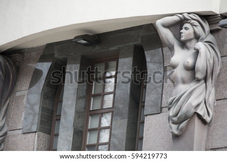 Facade of old building with statue of woman