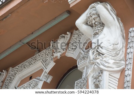 Facade of old building with statue 