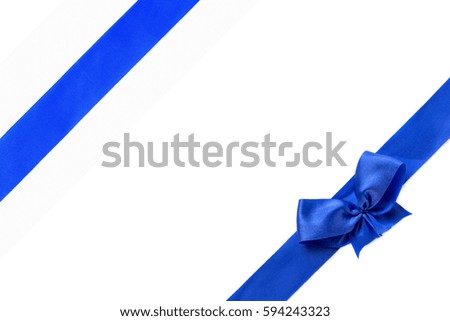 Blue shiny ribbon bow isolated on white background .