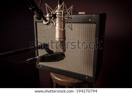 closeup of Electric guitar recording studio set up, with different microphones and amplifier, selective focus