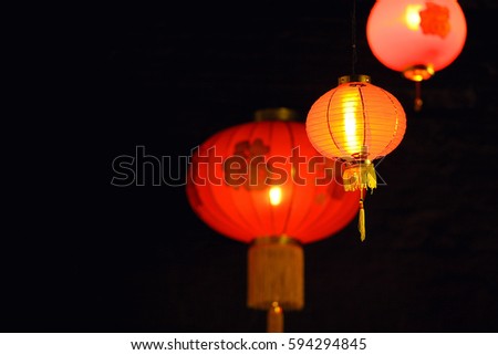 three red chinese lamp on black backgrounds
