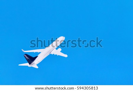 White blank model of passenger plane on blue background