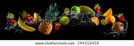 Fruits on black background with water splash Royalty-Free Stock Photo #594316418